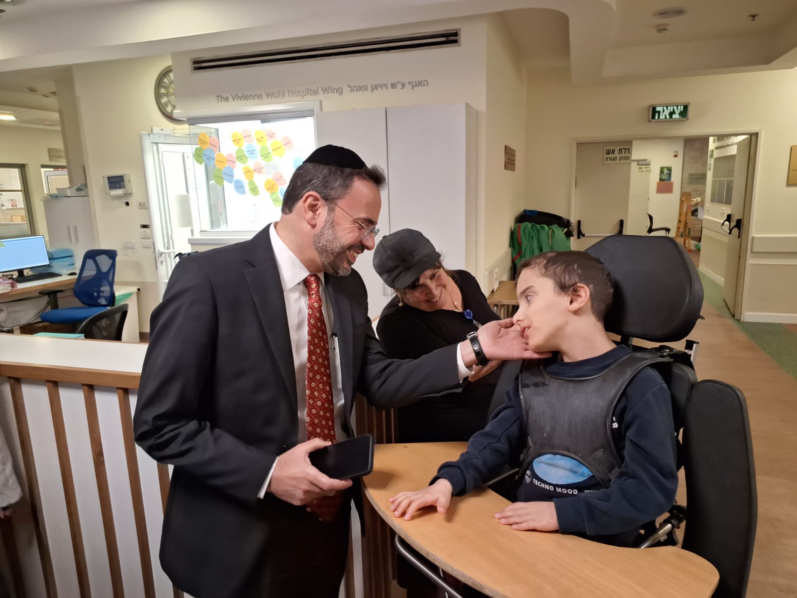 MInister of Health Uriel Busso and boy with disabilities שר הבריאות אוריאל בוסו ובחור עם מגבלויות